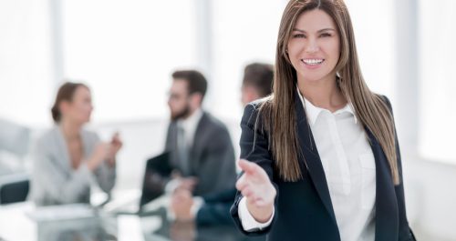 friendly business woman holding out her hand for a handshake .concept of partnership